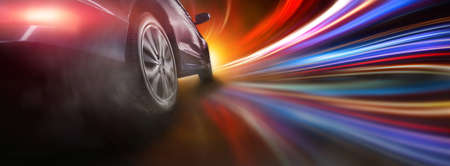 Sport car wheel drifting on night of city lighting background