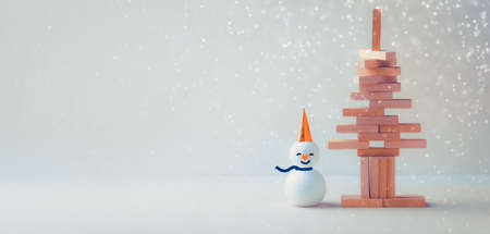 Stacked sticks in the shape of a Christmas tree with snowman. Christmas conceptの写真素材