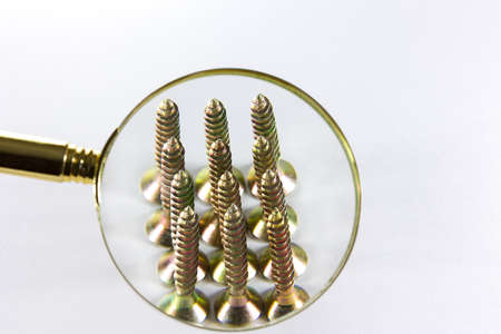 wood screws through a magnifying glassの写真素材