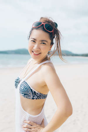 Thai woman smiling on the beachの写真素材