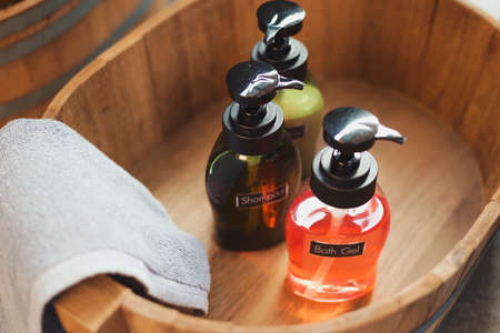 Bathroom amenity set in wooden bucket with vintage effect