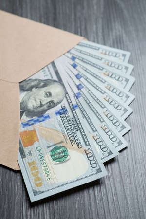 Money series : Open brown envelope with hundreds banknotes