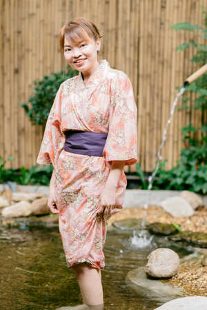Asian woman wearing yukata in Asian gardenの写真素材