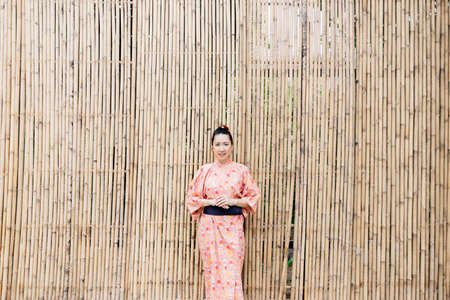 Lifestyle series : Asian woman in yukata in Asian gardenの写真素材