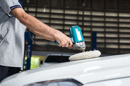 Car polishing series : Worker waxing white car