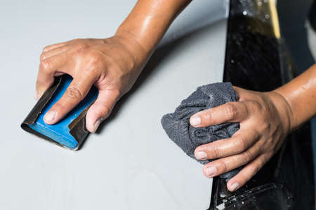 Auto body repair series : Hands of worker sanding putty