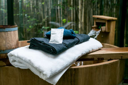 Onsen series : wooden bathtub with blue yukata and white towel