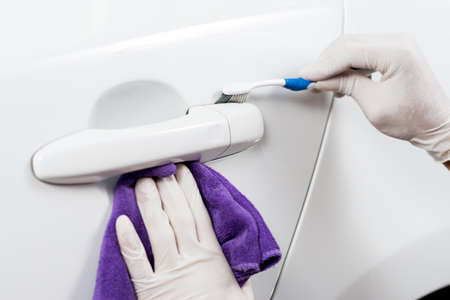 Car polishing series : Worker cleaning white car
