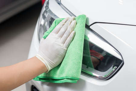 Car polishing series : Worker cleaning white car