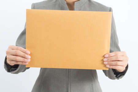 Asian office worker series : Holding brown paper envelopeの写真素材