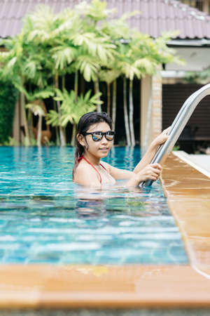 Swimming pool series : Asian woman in swimming poolの写真素材