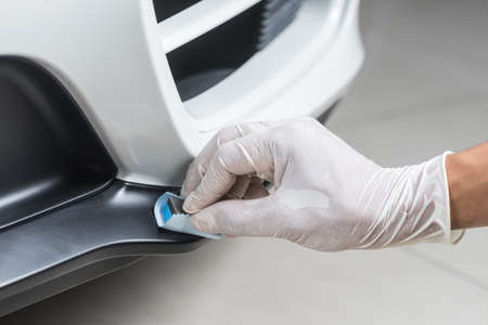 Car detailing series : Closeup of hand  coating plastic part