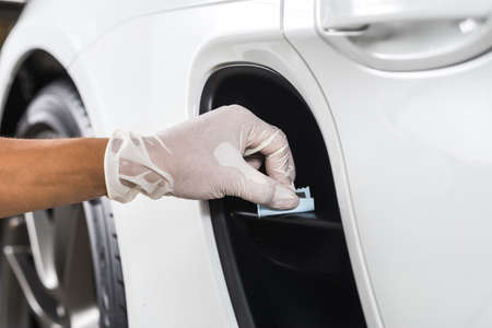Car detailing series : Closeup of hand  coating plastic partの写真素材