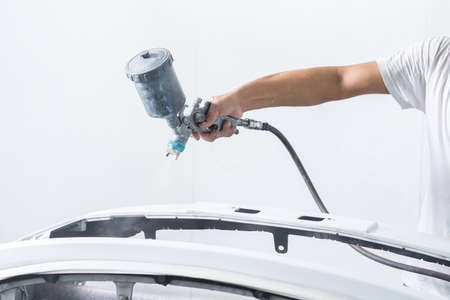 Auto body repair series : Painting car bumper in paint boothの写真素材