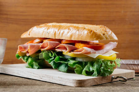 Food series : Baguette ham sandwich on wooden boardの写真素材