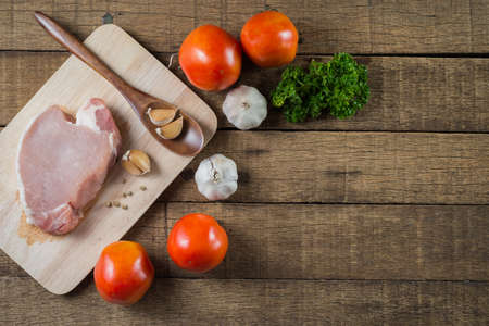 Food series : Raw pork on wooden cutting board and food ingredientsの写真素材