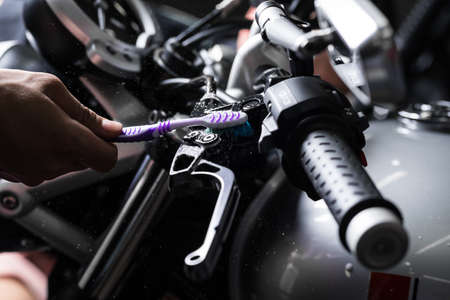 Motorcycles detailing series : Cleaning vintage motorcycle handlebar with toothbrushの写真素材