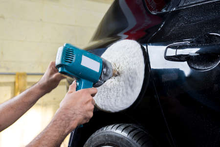 Auto body repair series : Closeup of polishing black car paint