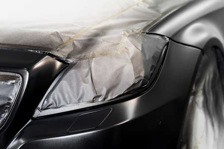 Auto body repair series: Black car being paint in paint boothの写真素材