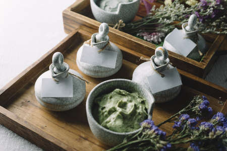Massage series: Massage amenity kit, ceramic container in wooden trayの写真素材