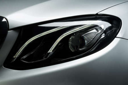 Car detailing series: Closeup of gray car headlight