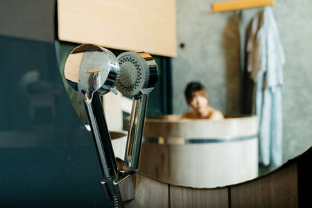 Onsen series: Asian womanâs reflections in mirror in wooden bathtubの写真素材