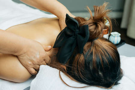 Aromatherapy massage series: Asian woman being massaged by therapistの写真素材