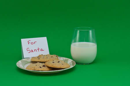 Cookies and Milk isolated on a green backgroundの写真素材