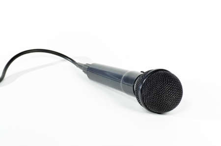 Black microphone with cord isolated against a white backgroundの写真素材