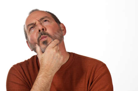 middle aged man with hand on beard looking up thinking