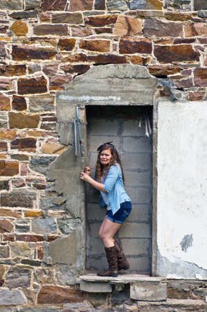 Teen Girl  posing outside old stone buildingの写真素材