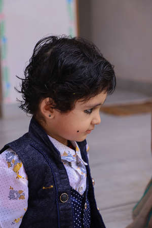 Cute Indian Boy Kid Giving Pose To Camera in very different emotions.