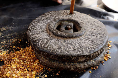 Tradition An Old Indian Hand Flour Mill. Grinding CHICKPEAS .の写真素材