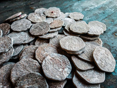 Ancient silver coins on a dark wooden background. Selective focus.の写真素材
