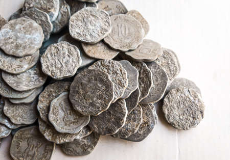 Ancient silver coins of the Roman Empire on a white wooden background.の写真素材