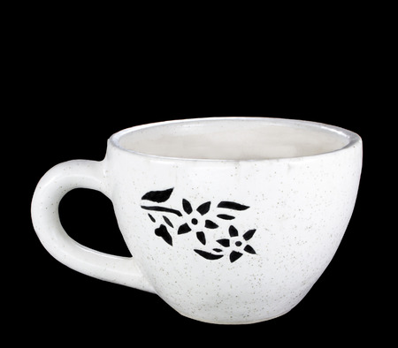 Cup Shaped off white Ceramic Pot for plant flower with flower pattern on black backgroundの写真素材