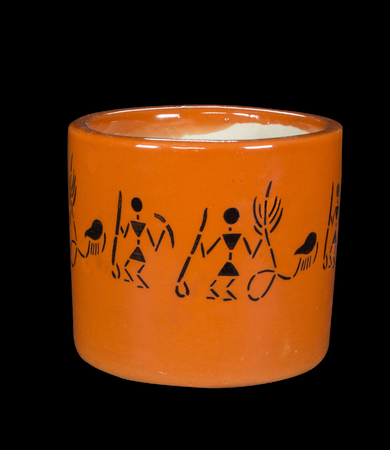 Round Orange Ceramic Pot for plant flower with tribal pattern on black backgroundの写真素材