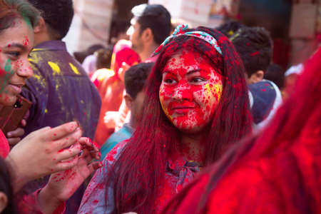 Jodhpur, rajastha, india - March 20, 2020: Young indian girl celebrating holi festival, face covered with colored powder.のeditorial素材