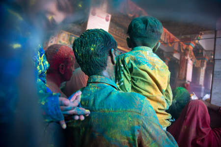 Jodhpur, rajastha, india - March 20, 2020: Young indian father and son celebrating holi festival, closeup of face covered with colored powder.のeditorial素材