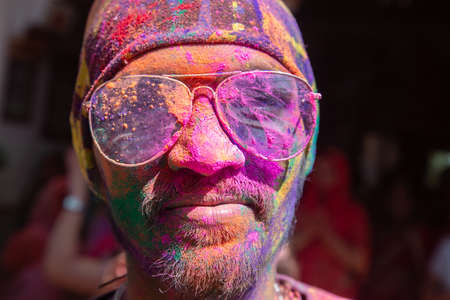 Jodhpur, rajastha, india - March 20, 2020: Portrait of young indian men wearing goggles celebrating holi festival, closeup of face covered with colored powder.のeditorial素材