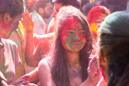 Jodhpur, rajastha, india - March 20, 2020: Young indian girl face covered with colored powder, celebrating holi festival, outdoorのeditorial素材