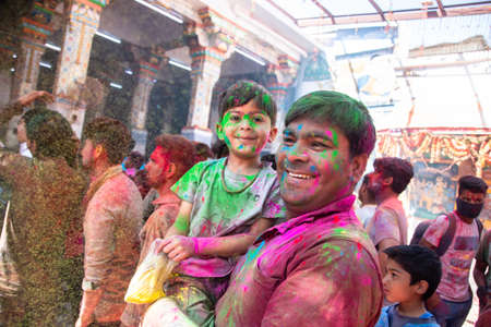 Jodhpur, rajastha, india - March 20, 2020: Young indian father and son celebrating holi festival, closeup of face covered with colored powder.のeditorial素材