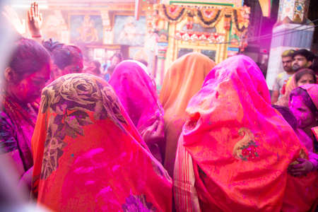 back view of indian women wearing saree celebrating holi festival with colored powder. backgroundのeditorial素材