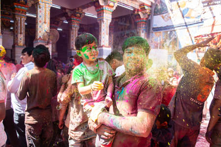 Jodhpur, rajastha, india - March 20, 2020: Young indian father and son celebrating holi festival, closeup of face covered with colored powder.のeditorial素材