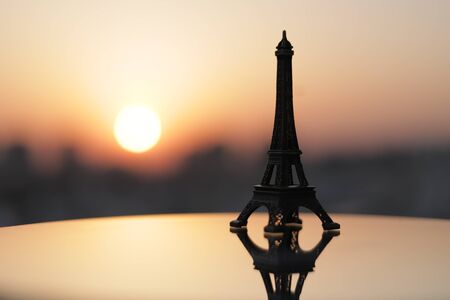 Eiffel Tower in Paris at sunrise & sunset. Small Eiffel Tower With Sun.の写真素材