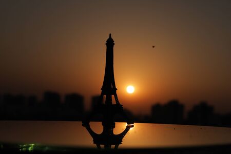 Eiffel Tower in Paris at sunrise & sunset. Small Eiffel Tower With Sun.の写真素材