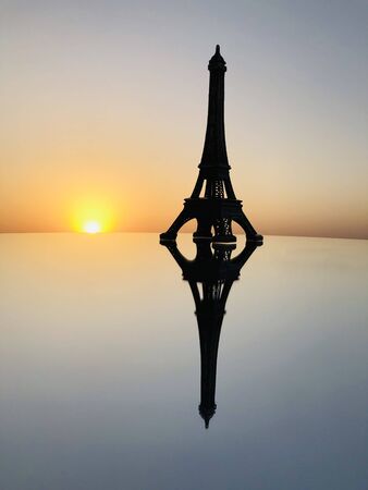 Eiffel Tower in Paris at sunrise & sunset. Small Eiffel Tower With Sun.の写真素材