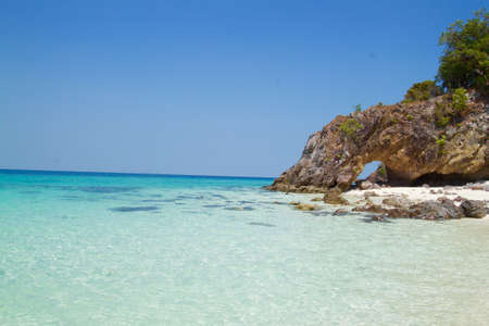 The rocks that penetrate the channel as a symbol to tourists to visit. There is also a clear blue sea and white sand beach.の写真素材