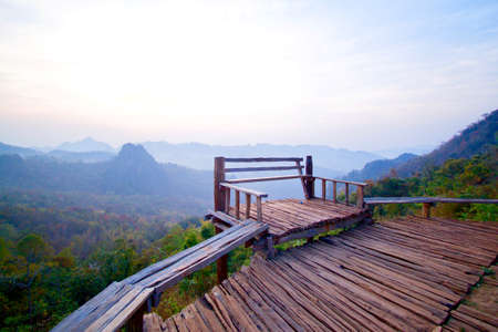 Wooden terrace overlooking the cliffside sunrise. Can watch the sunrise and mist at the same time.の写真素材