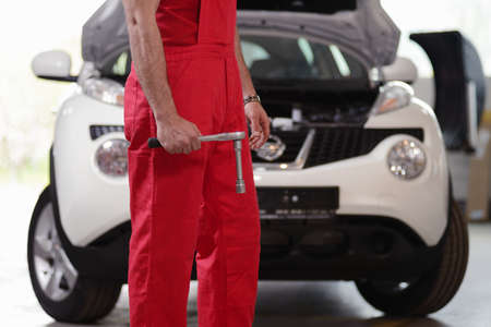 Mechanic repairing a car in garageの写真素材